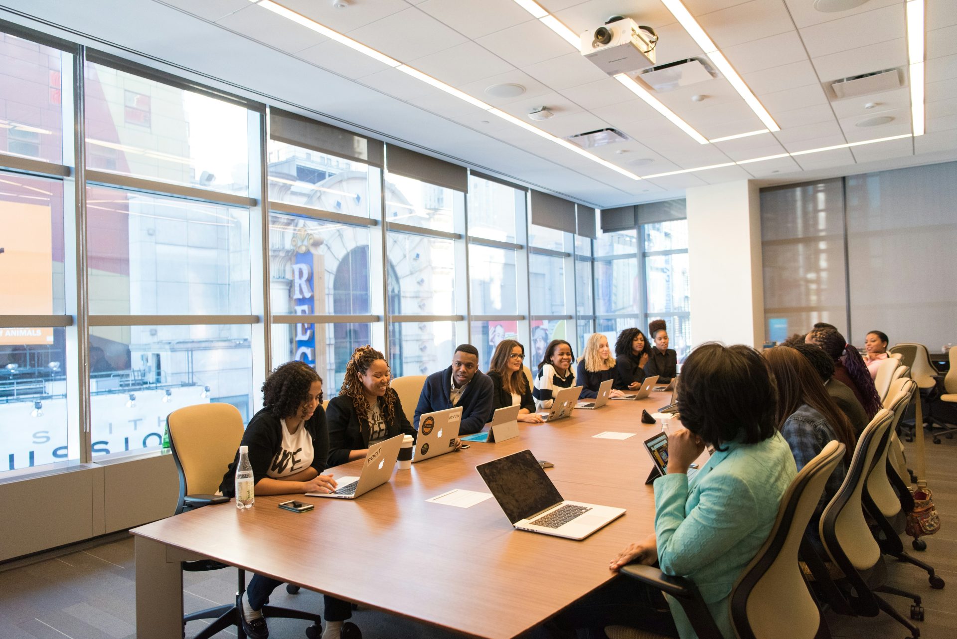 Large group in a meeting, laptops open