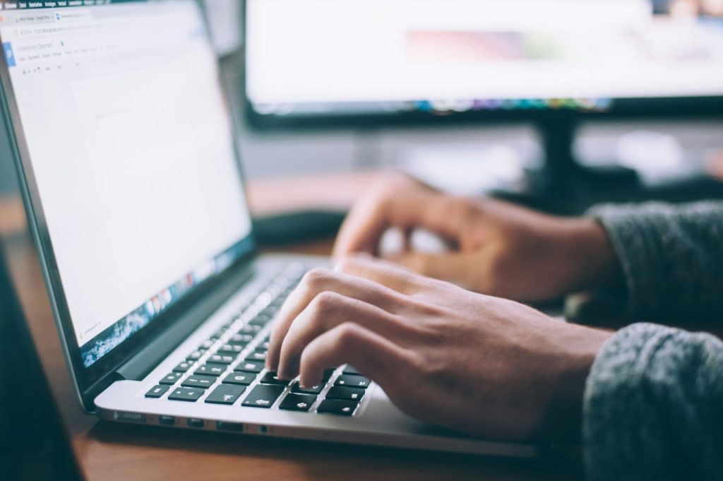 Person typing on laptop in office environment