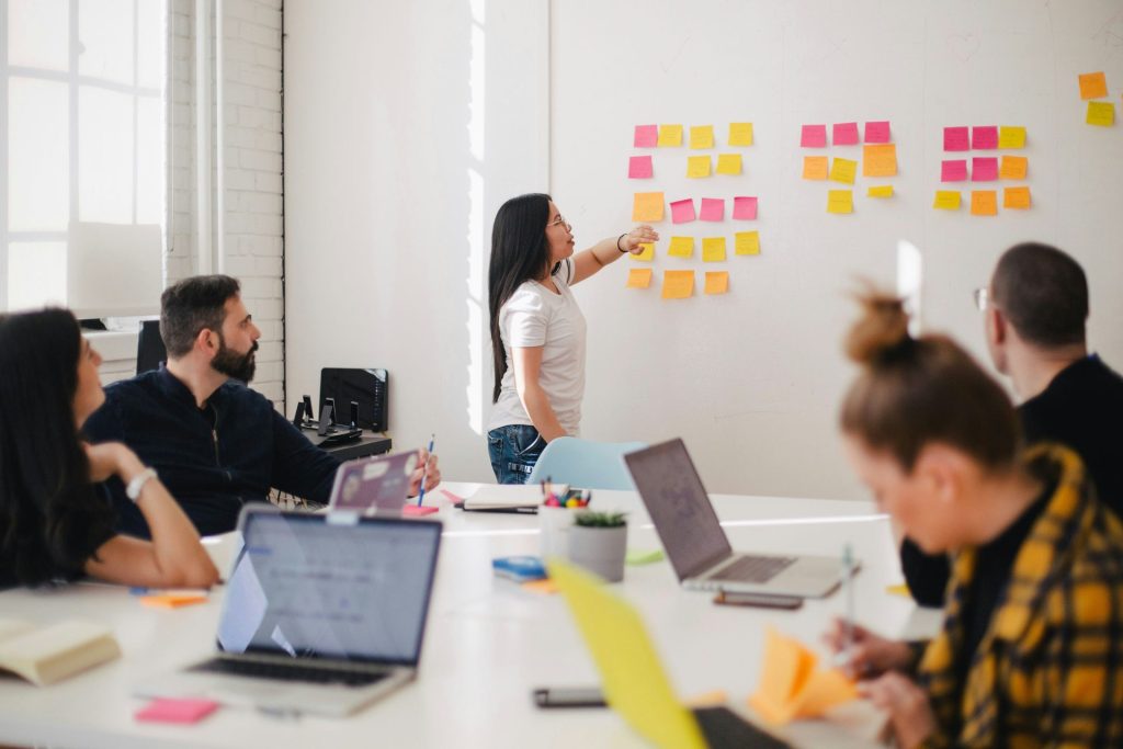 Woman leading a meeting with sticky notes