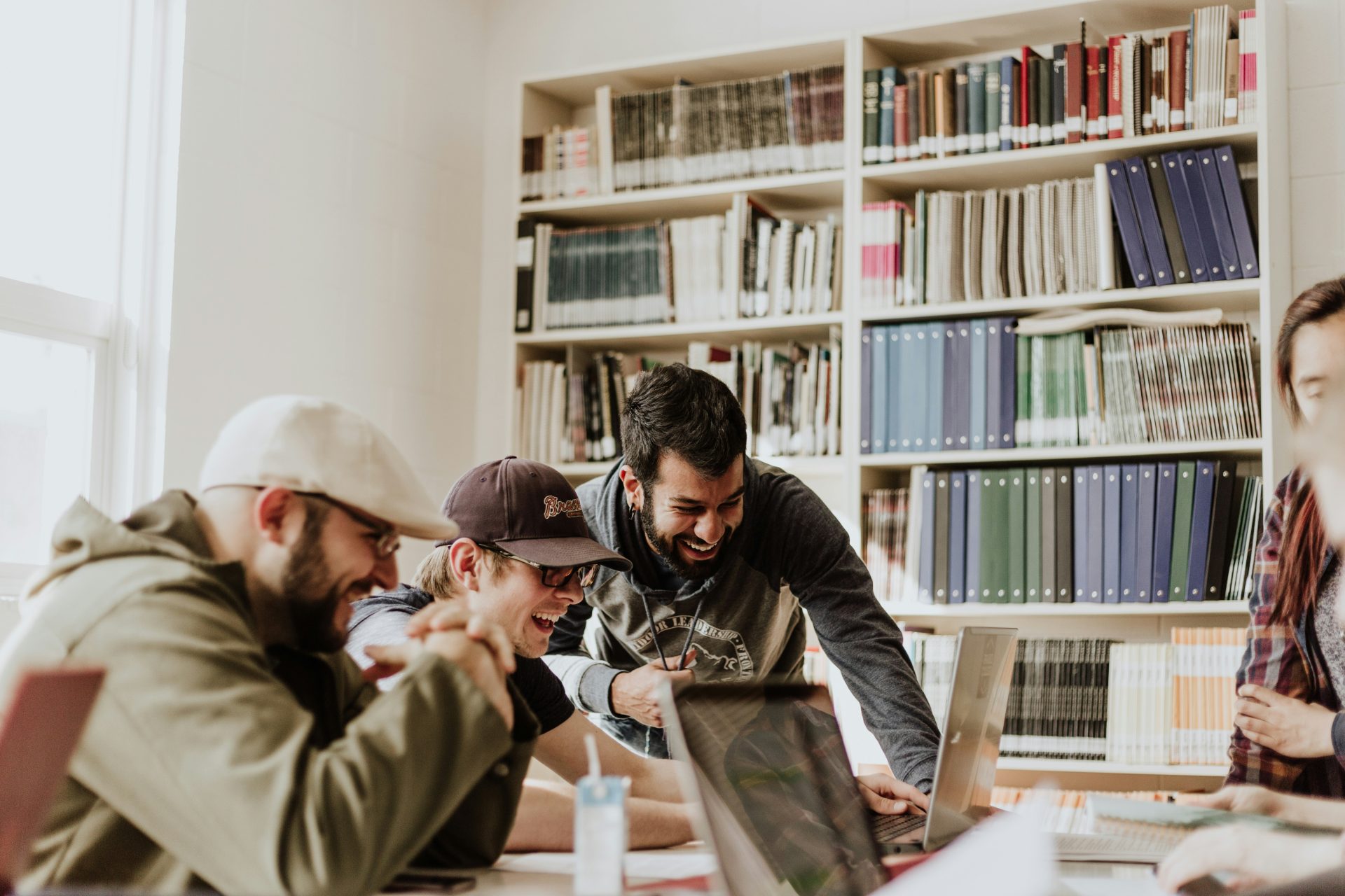 Group of people laughing in library setting